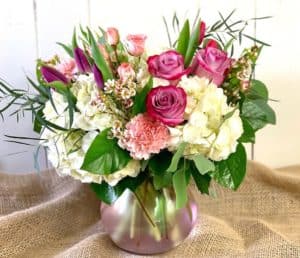 Our favorite pink Lula vase served up with white hydrangea, lavender roses, pink tulips, and more. Perfect for anyone who loves pinks, purples, or pretty!