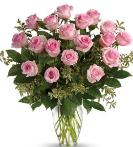 Say it sweeter with this feminine bouquet of up to three dozen ballet pink roses and lush greens in a graceful glass vase.