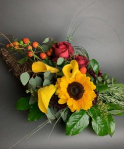 An arrangement so unique and lovely, this lush autumn cornucopia is styled with premium blooms and foliage