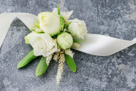 Corsage with white flowers and ribbon